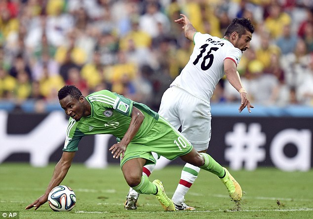 Mikel and Ghoochannejhad battle for the ball.
